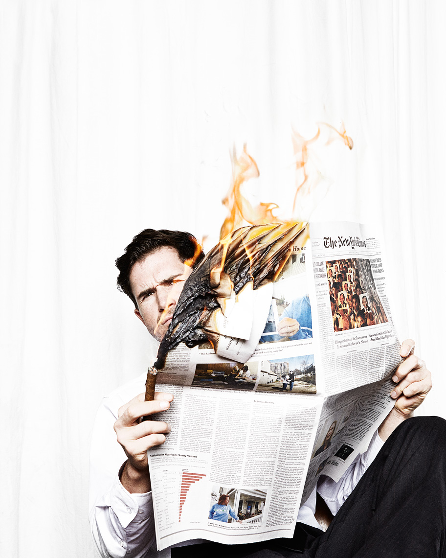 Guy reading a burning newspaper